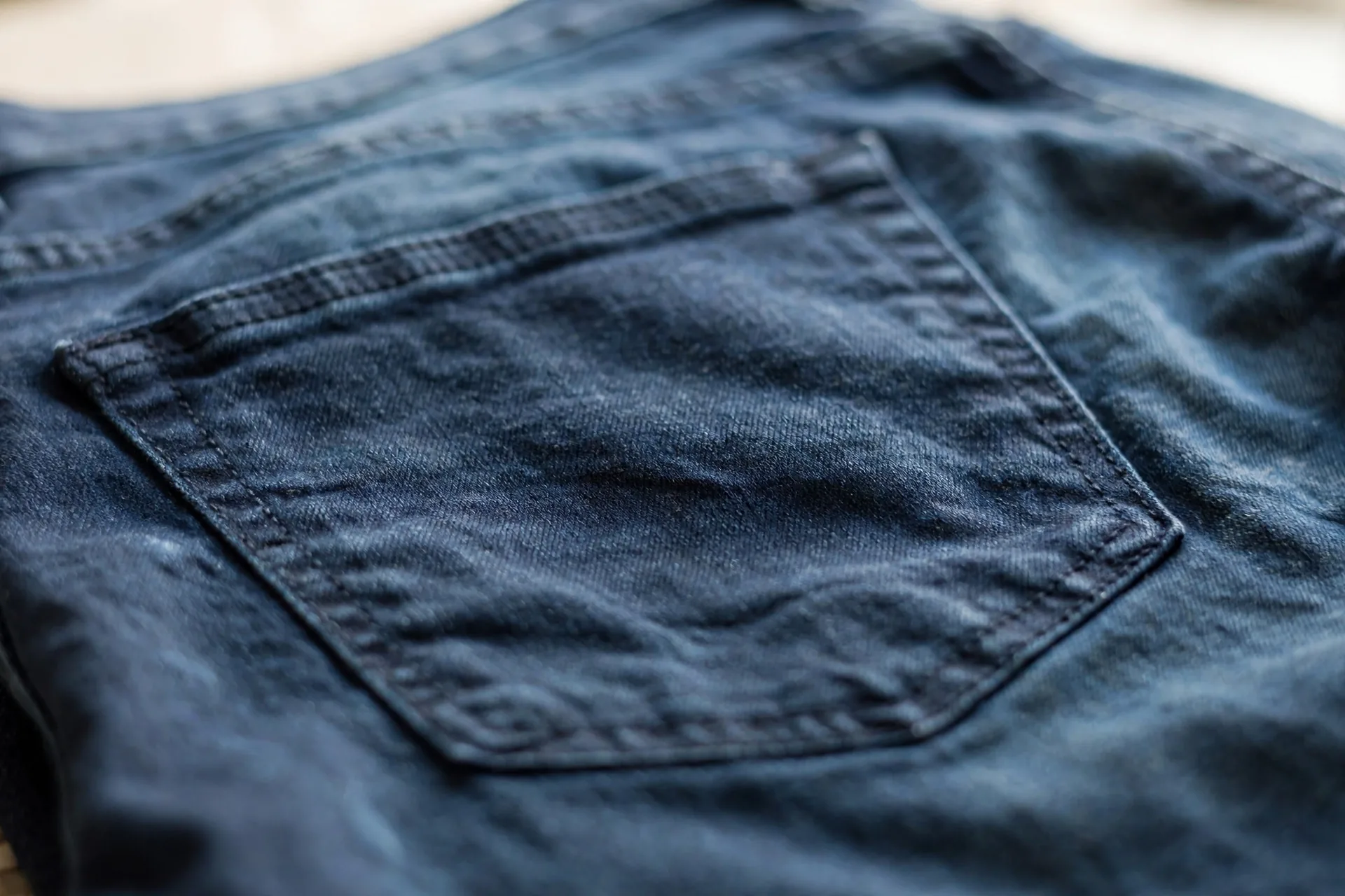 Detail of jeans back pocket and clean dark denim