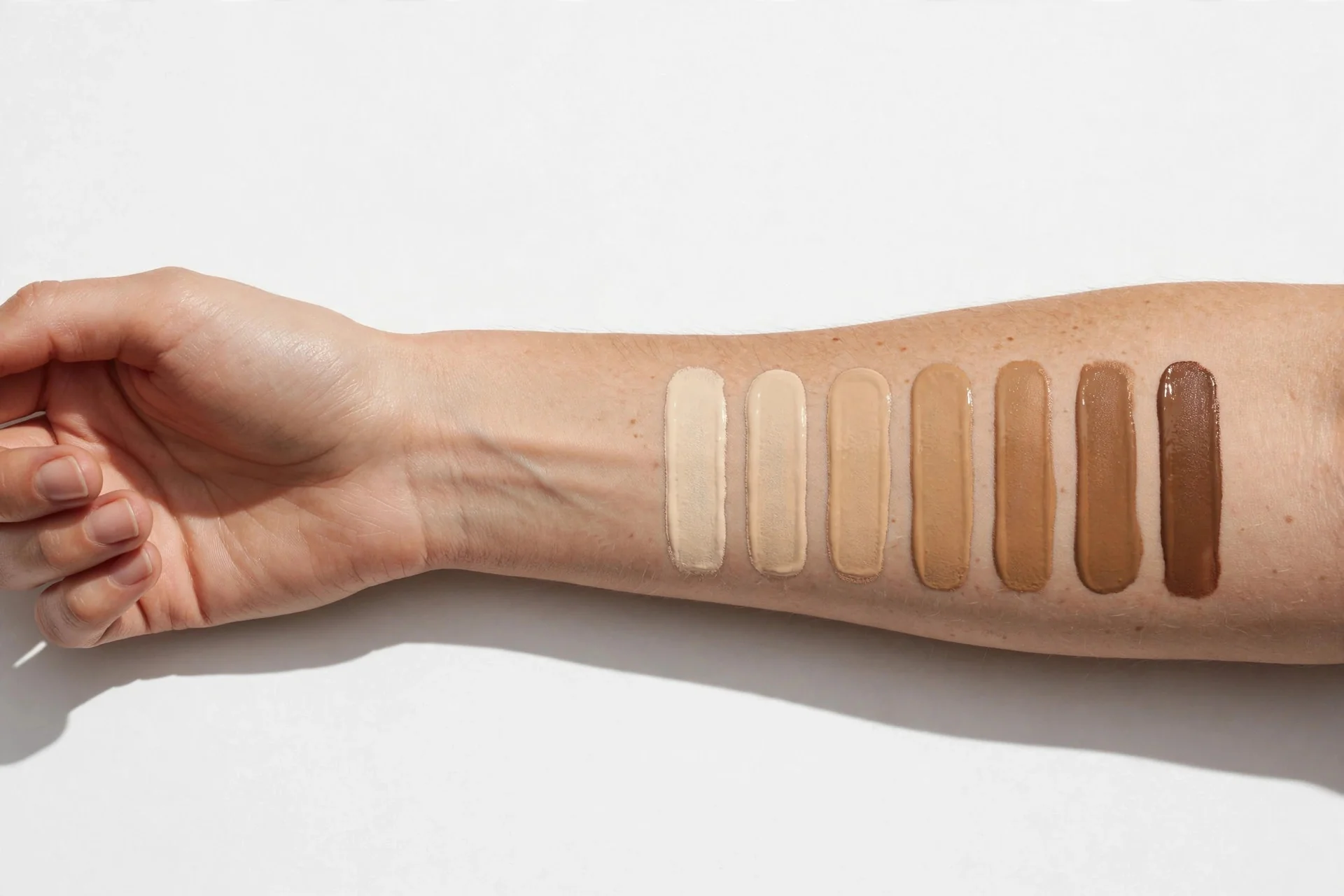Swatching foundation shades on an inner forearm to find your foundation shade and undertone