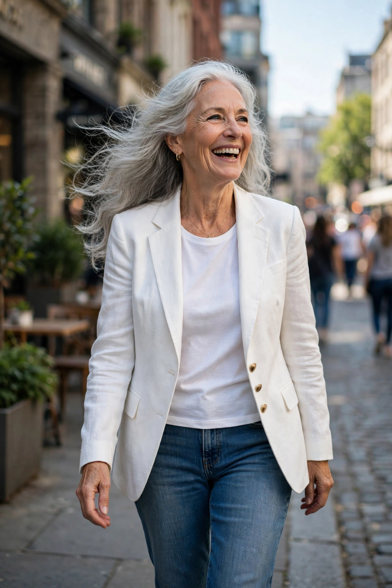Confident woman in her 60s with long silver hair in street style