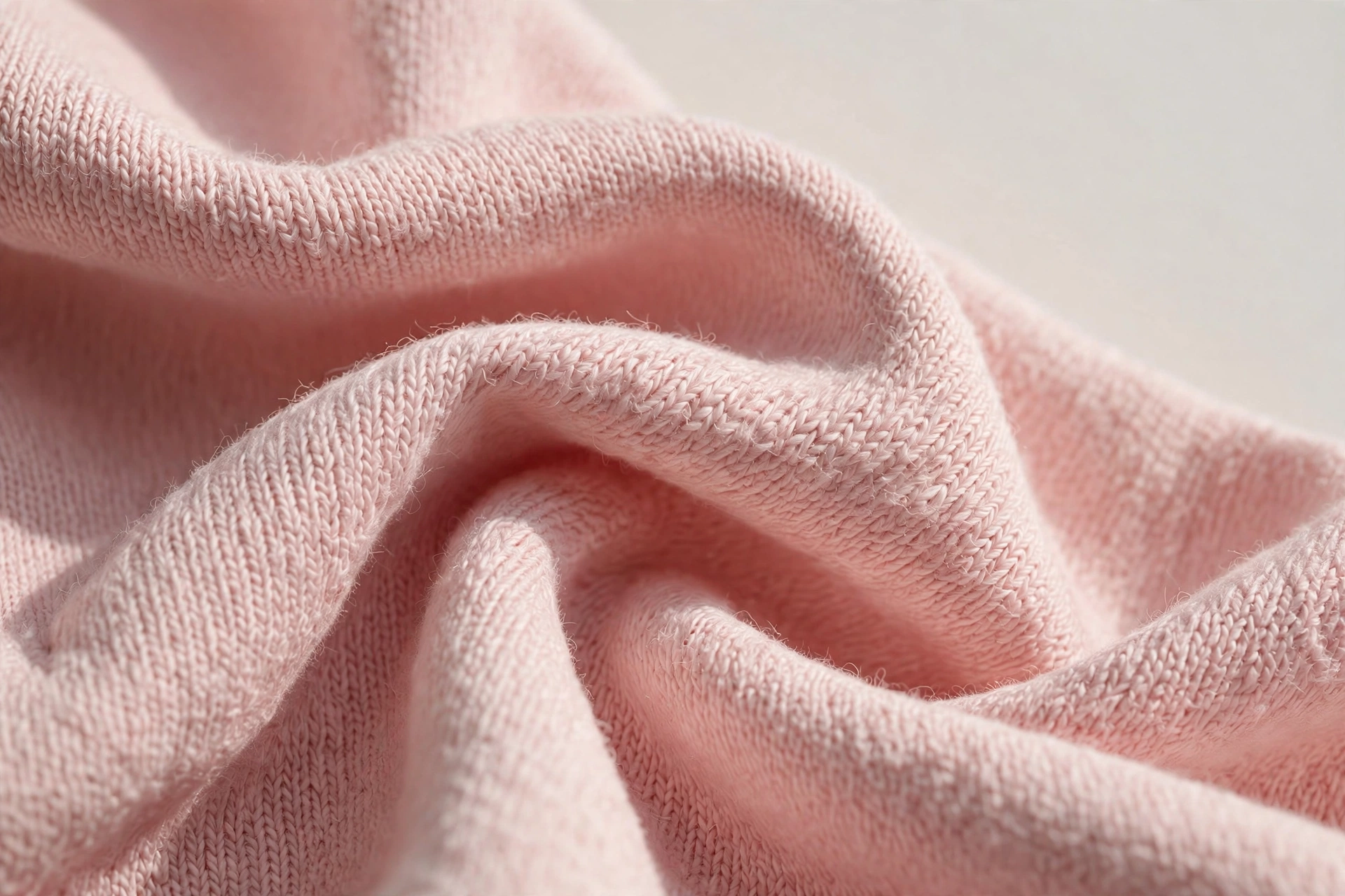 Close-up of soft blush pink cotton jersey fabric, gentle and breathable for sensitive skin