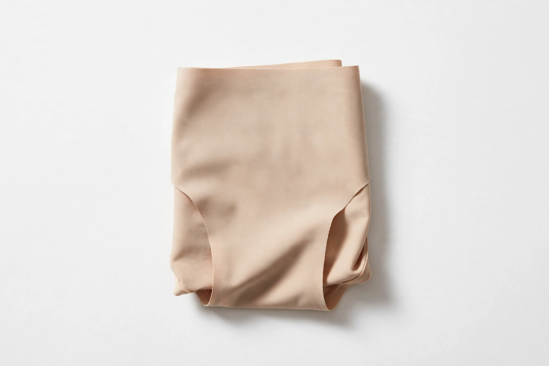 Folded nude beige seamless women's briefs — invisible no-show underwear for women over 50