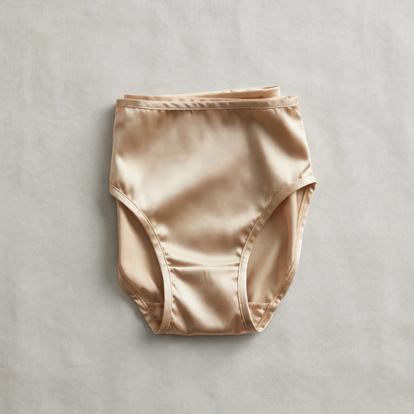 Folded champagne satin women's briefs — an elegant touch for special nights